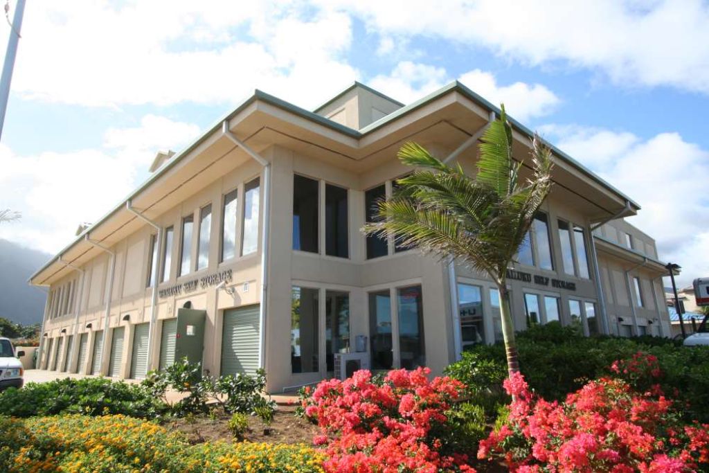 A large house with flowers in front of it.