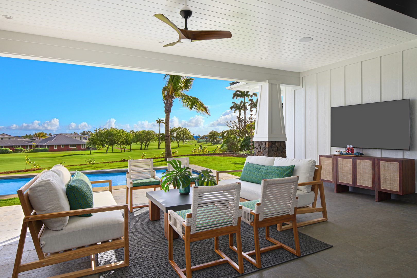 A patio with furniture and a pool in the background.