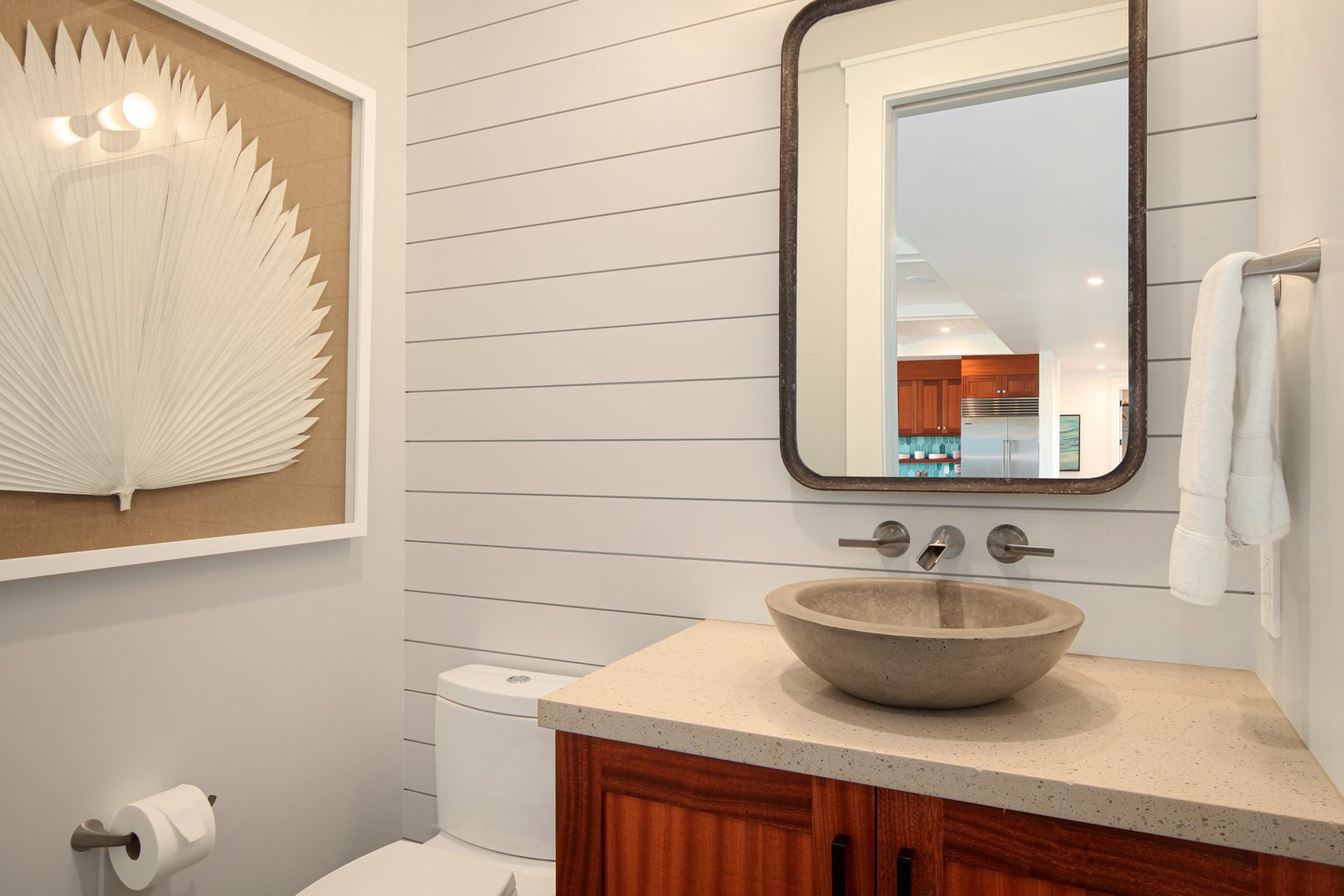 A bathroom with a sink and mirror in it