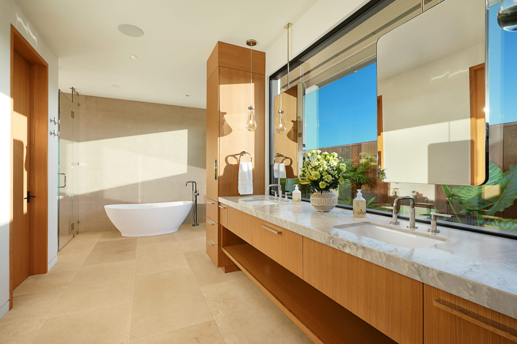 A bathroom with a large mirror and a tub.