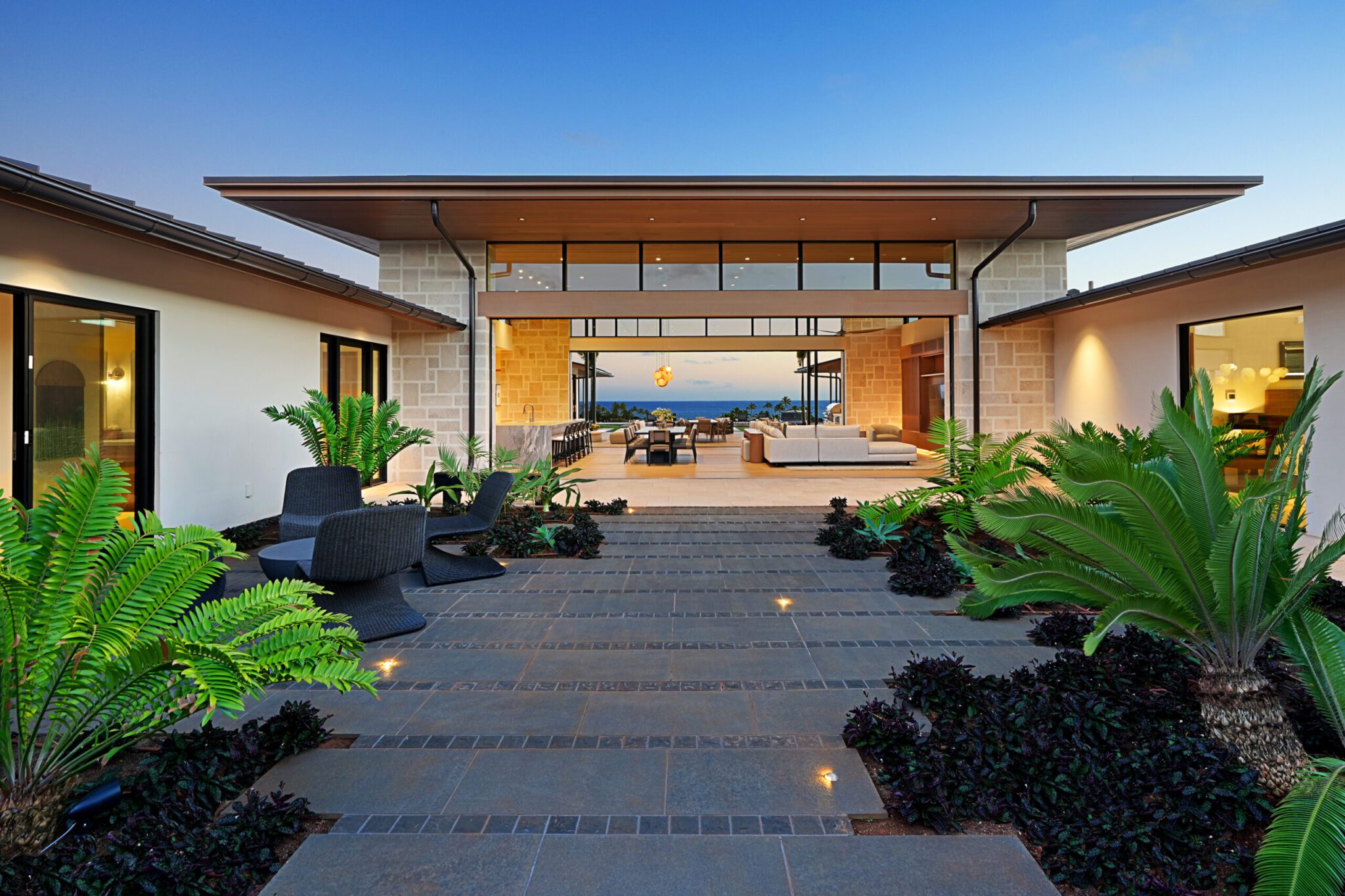 A large patio with plants and lights in the middle of it.