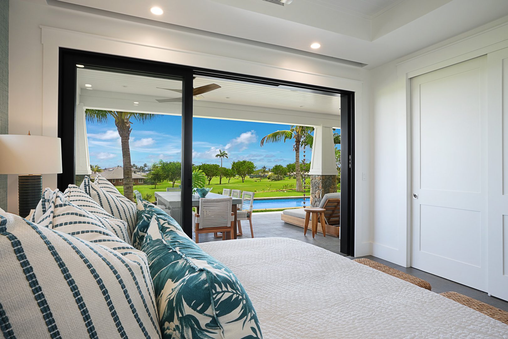 A bedroom with sliding glass doors open to the patio.