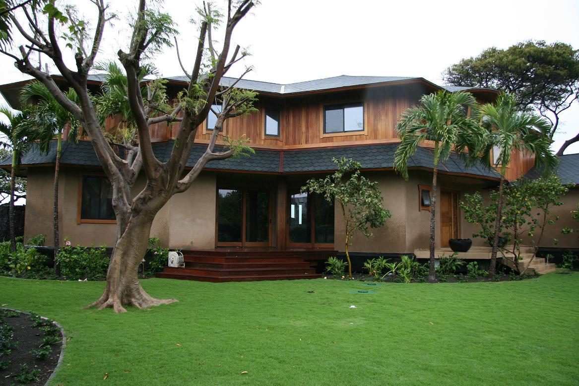 A large house with a tree in the yard