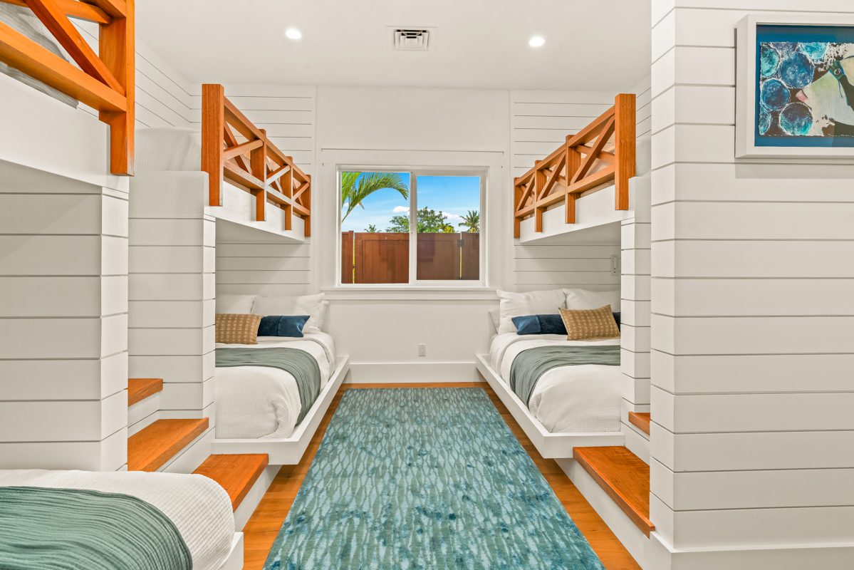 A room with two beds and a window.