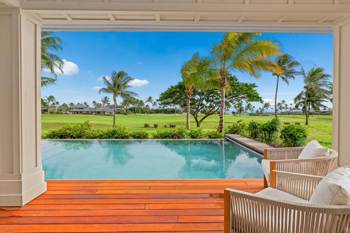 A pool with an open view of the grass.