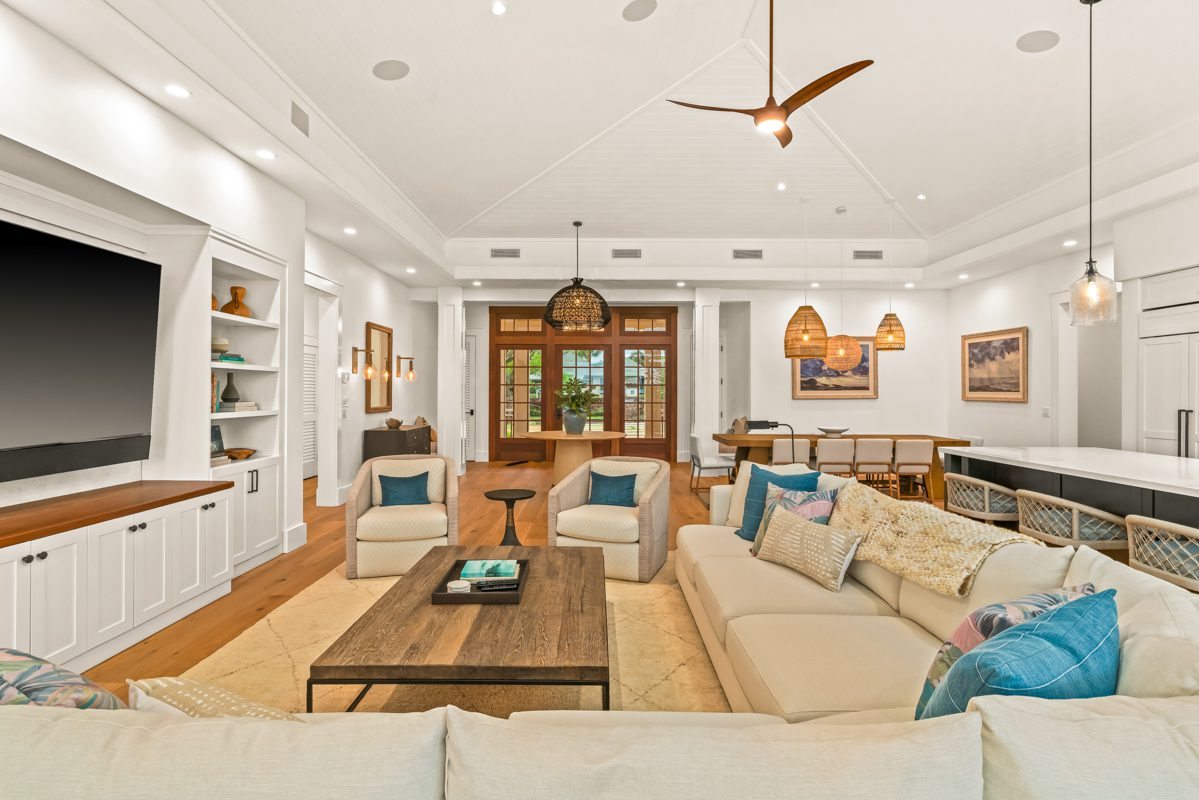 A living room filled with furniture and a large window.