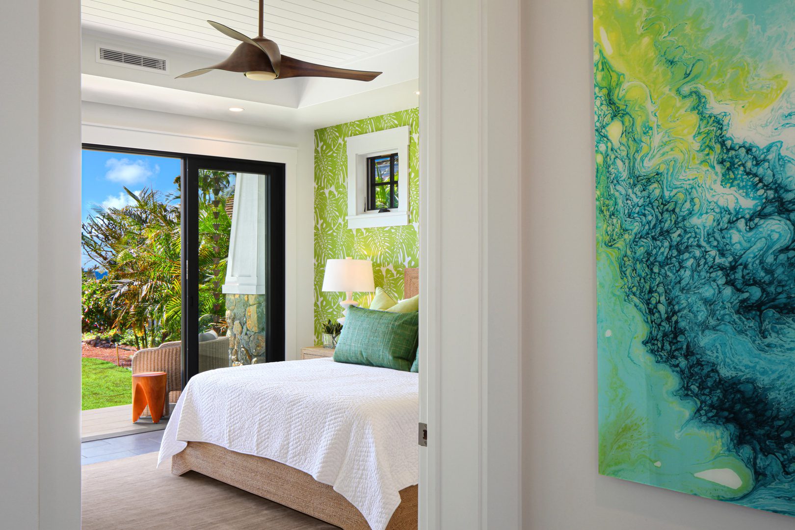 A bedroom with a bed and a painting on the wall