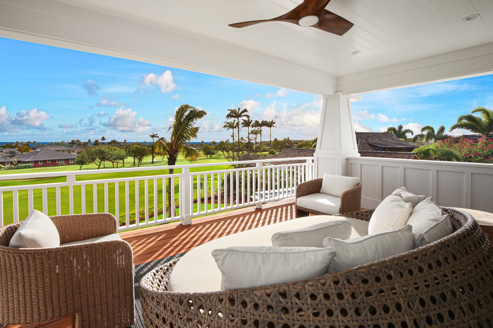 A porch with a couch and chairs on it