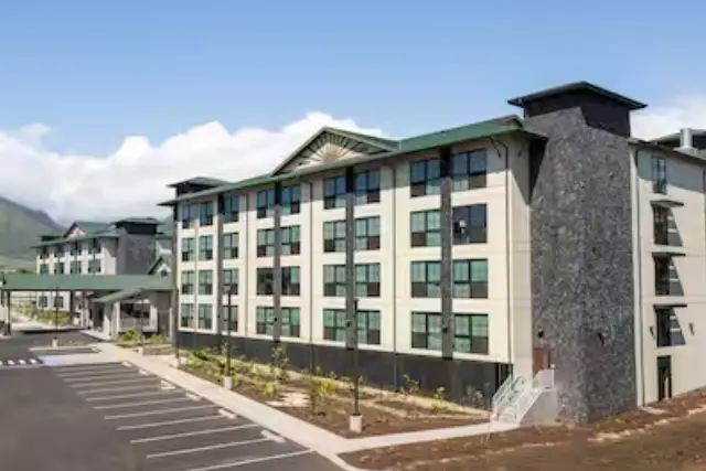 A large building with many windows and a green roof.